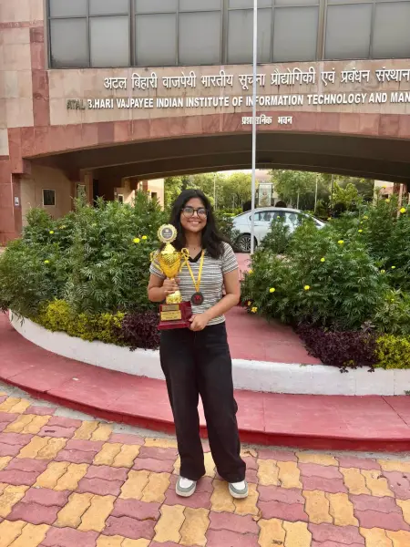An ATF fellow holding her trophy outside the Atal Bihari Vajpayee Indian Institute of Information Technology and Management building at Gwalior
