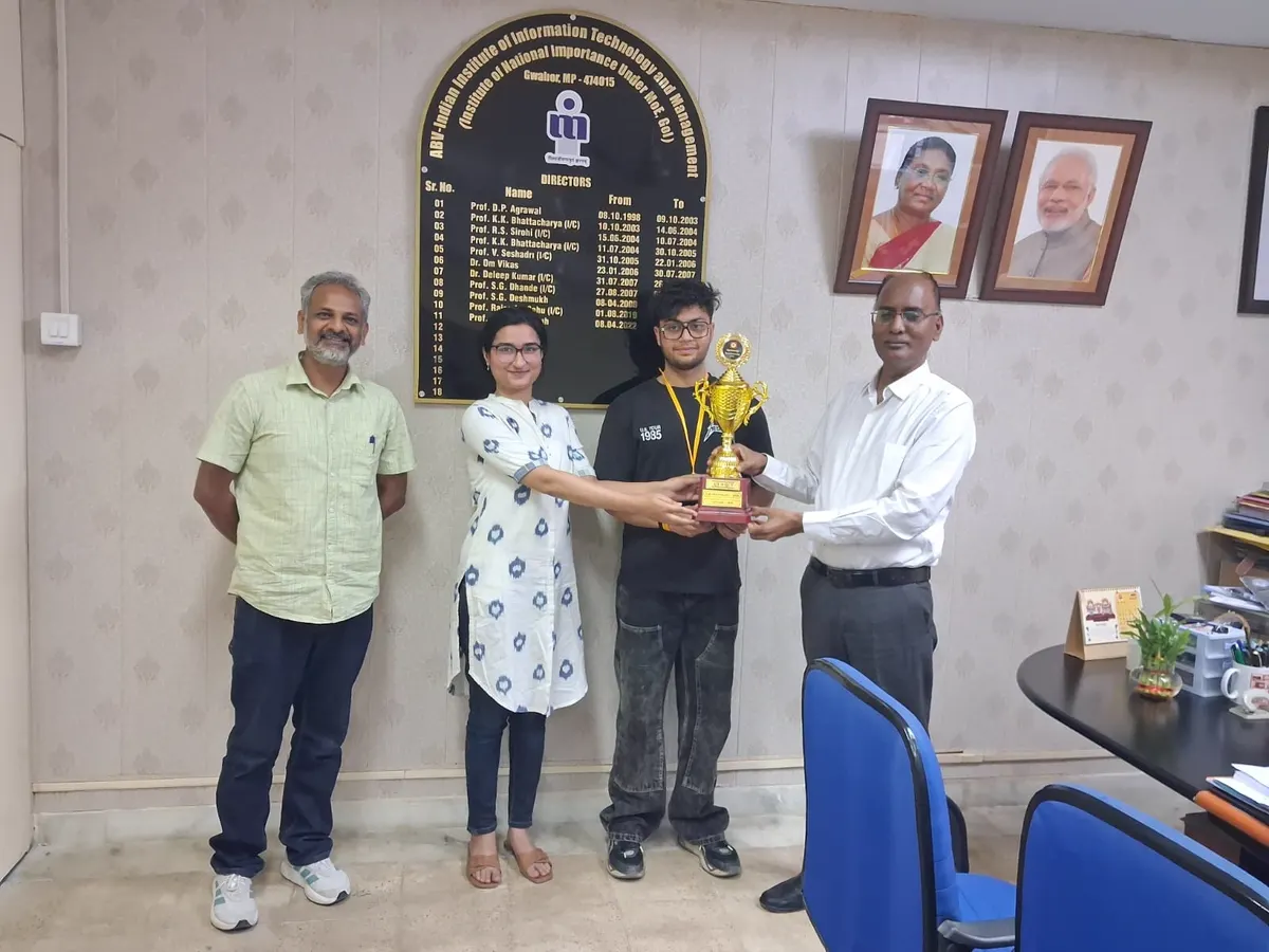 Fellows holding the ATF trophy with faculty members either side of them at IIIT Gwalior