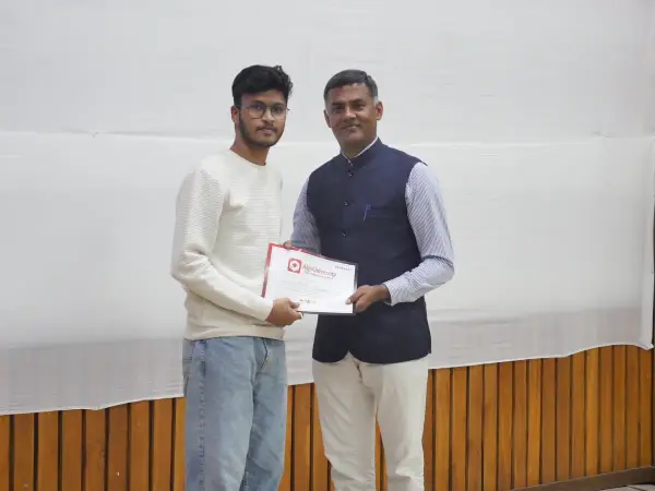 A student receiving an ATF certificate from an AlgoUniversity representative at the IIT Guwahati felicitation ceremony