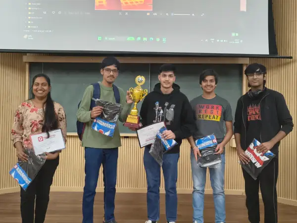 Five ATF fellows standing together holding a trophy, certificates and AlgoUniversity kits at IIT Mandi